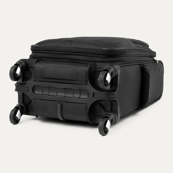 bottom view of black travelpro maxlite 5 compact carry-on spinner showing four wheel spinner system and molded corner guards.