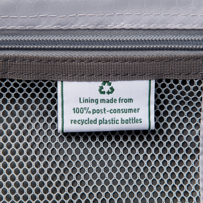 close up of interior lining tag in black travelpro maxlite 5 compact carry-on spinner stating lining made from 100 percent post consumer recycled plastic bottles.