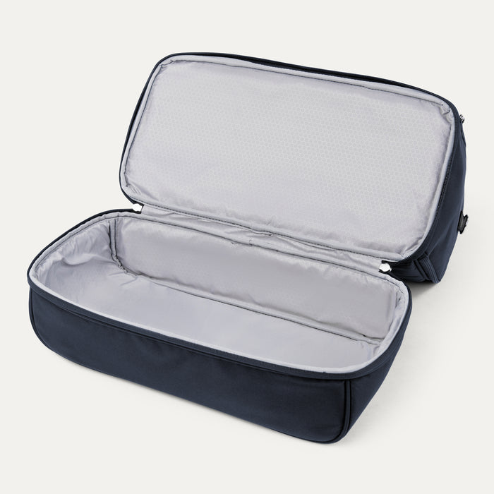 interior view of the open drop bottom compartment on the midnight blue travelpro maxlite 5 weekender showing the spacious storage area with light gray lining.