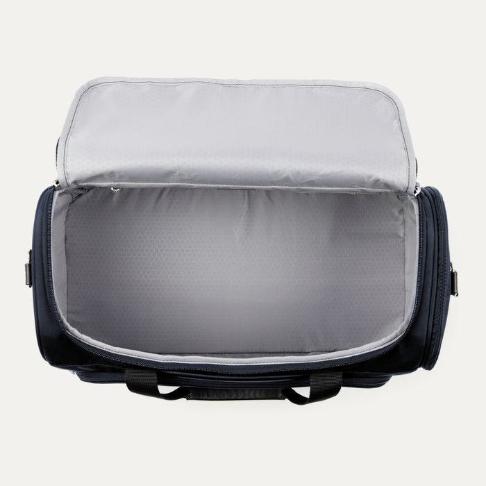 top down interior view of the open main compartment on the midnight blue travelpro maxlite 5 weekender showing the large packing space and light gray moisture resistant lining.