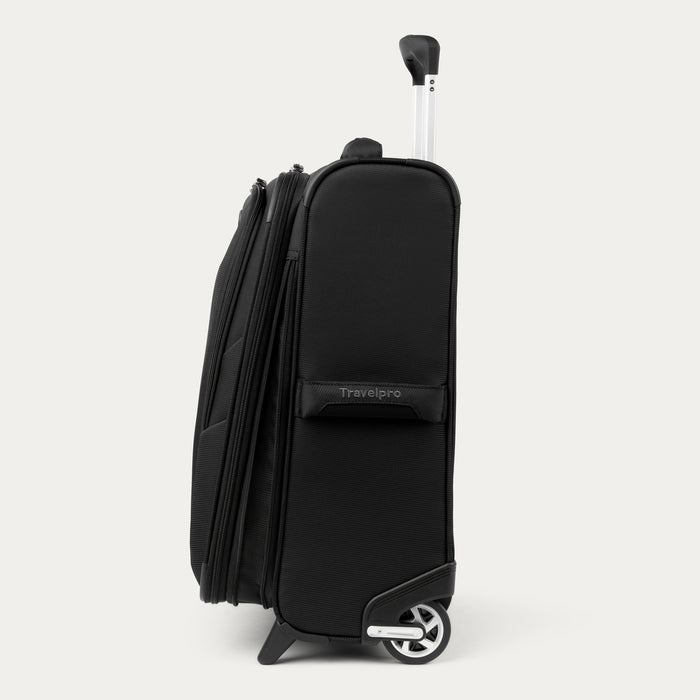 side view of the black travelpro maxlite 5 international carry-on rollaboard showing the slim profile, high-performance ball bearing wheels, and the fully extended powerscope lite handle.