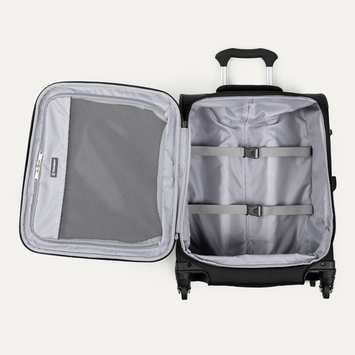 interior view of the open black travelpro maxlite 5 international carry-on spinner showing the light gray ecofab lining, a large interior mesh zippered lid pocket, and adjustable hold-down straps in the main compartment.