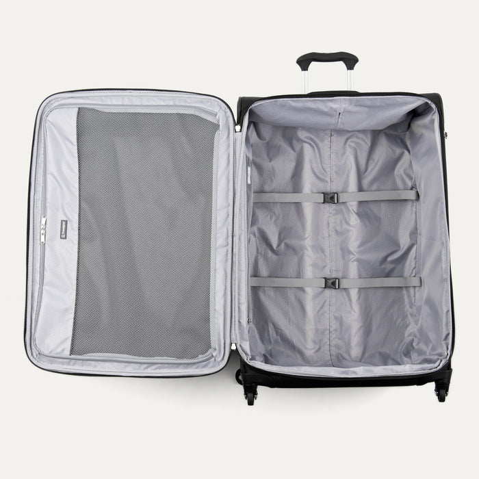 interior view of the open black travelpro maxlite 5 large check-in spinner showing the roomy main compartment with adjustable hold-down straps and a full-length interior lid pocket.
