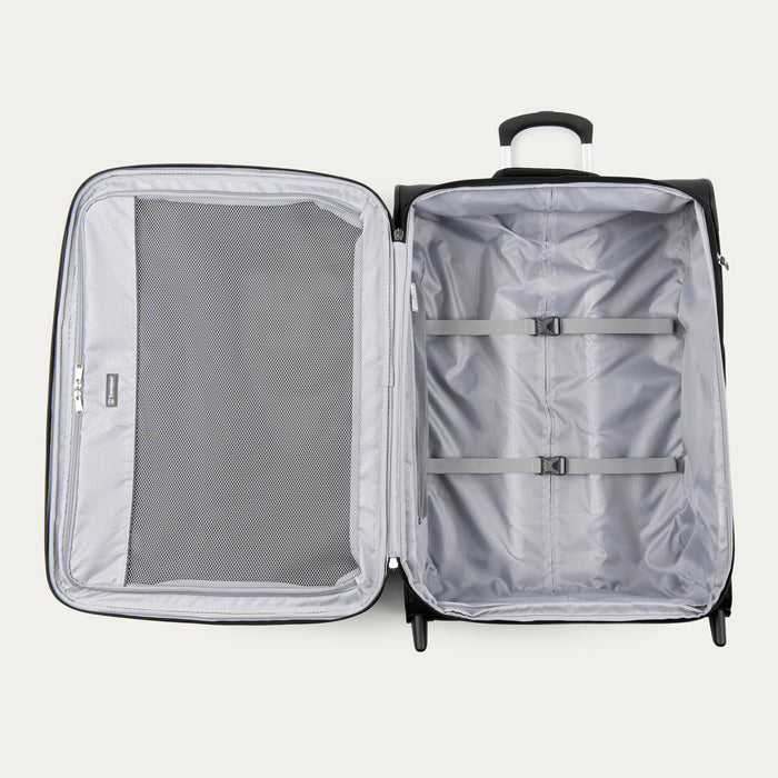 interior view of the open black travelpro maxlite 5 medium check-in rollaboard showing the light gray ecofab lining, a large interior mesh zippered lid pocket, and adjustable hold-down straps in the main compartment.