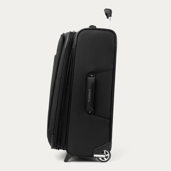 side profile view of the black travelpro maxlite 5 medium check-in rollaboard suitcase showing its slim profile, side carry handle, and high-performance ball-bearing wheels.