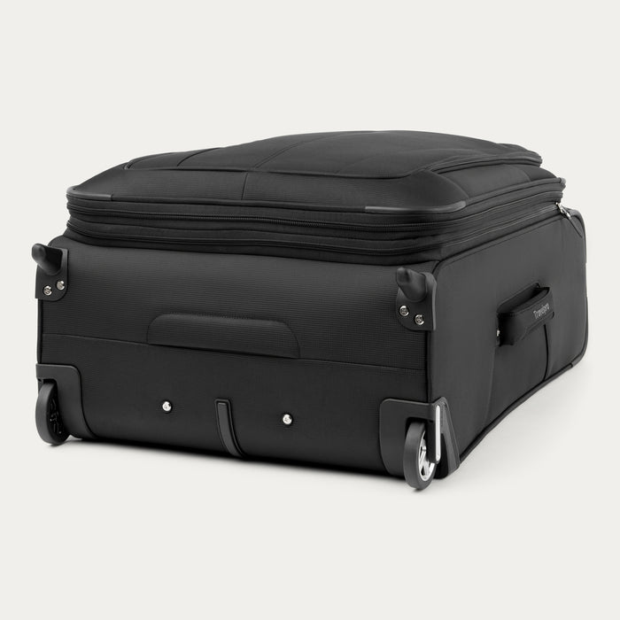 bottom view of the black travelpro maxlite 5 medium check-in rollaboard suitcase showing two high-performance ball-bearing wheels, protective wheel housings, front stabilizer feet, and a bottom grab handle.