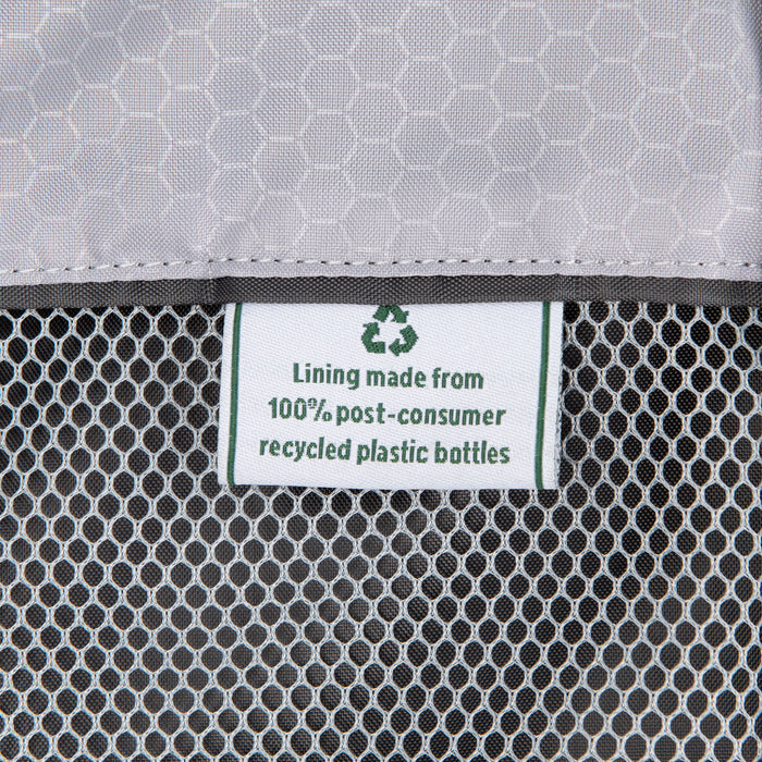 close up of the interior fabric tag on the black travelpro maxlite 5 rolling carry on garment bag stating lining made from 100 percent post consumer recycled plastic bottles with a green recycling symbol.