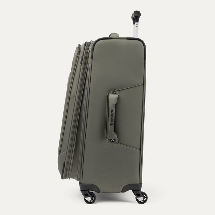 side profile view of the slate green travelpro maxlite 5 softside spinner showing the expanded main compartment, side carry handle with travelpro branding, and low-profile spinner wheels.
