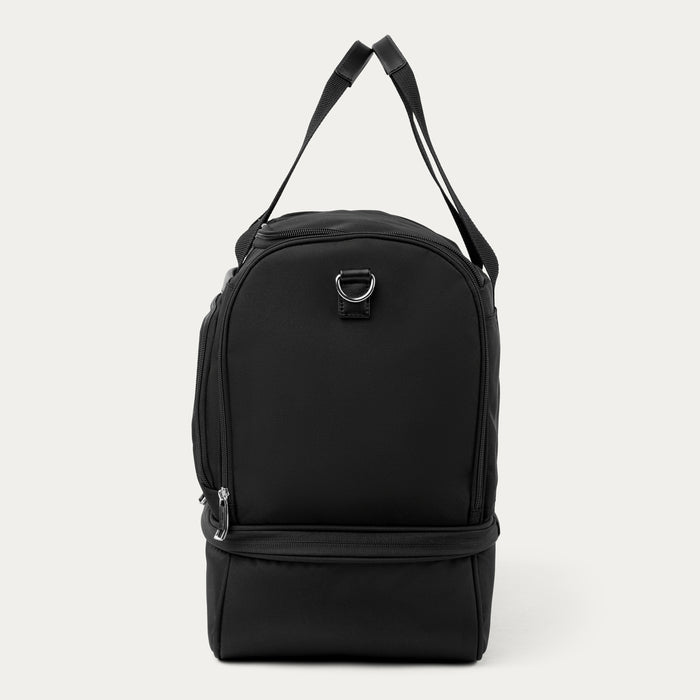 side view of the black travelpro maxlite 5 drop bottom weekender showing the lower compartment and carry straps.