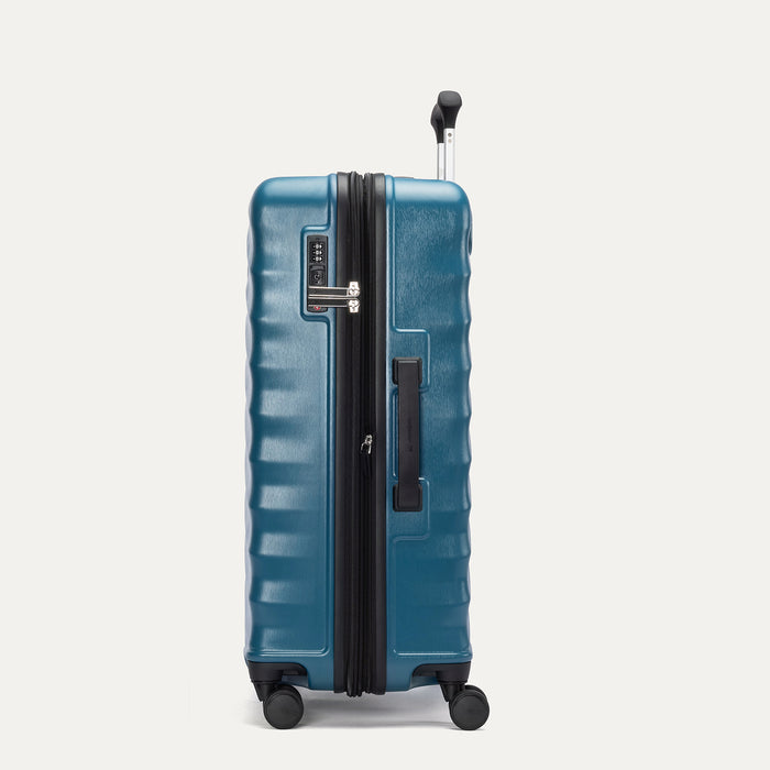 Side view of Travelpro Maxlite Air V2 Check-In Spinner in Teal, showing expandable zipper, Low-Profile Side Carry Handle, and extended PowerScope Lite Handle.