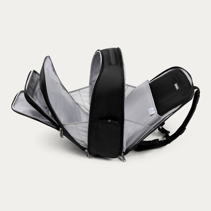 side view of black travelpro maxlite laptop backpack with all storage compartments and laptop sleeve fully open.