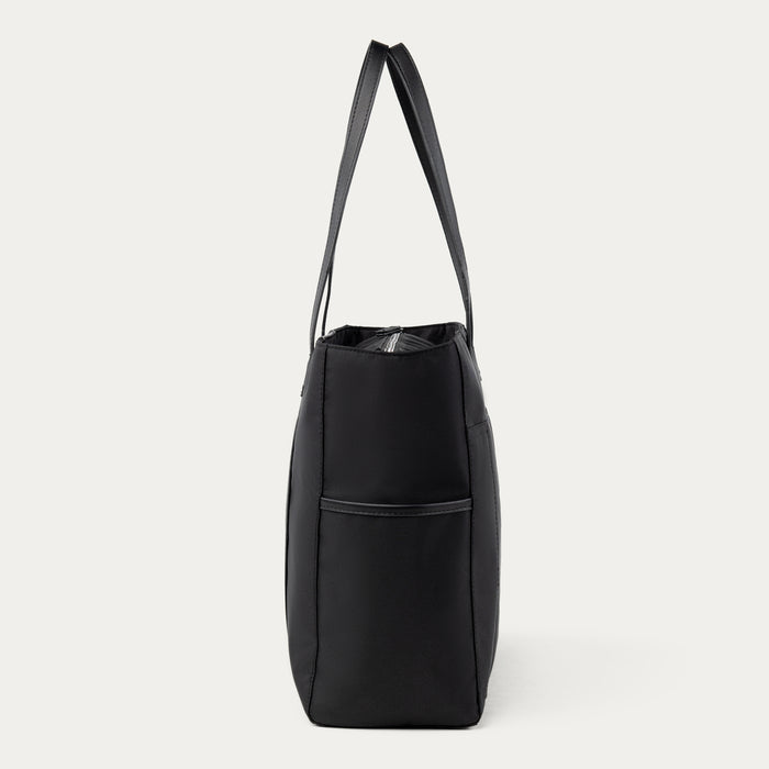 side profile view of black travelpro maxlite women's tote showing the slim design and side exterior pocket for a water bottle or umbrella.