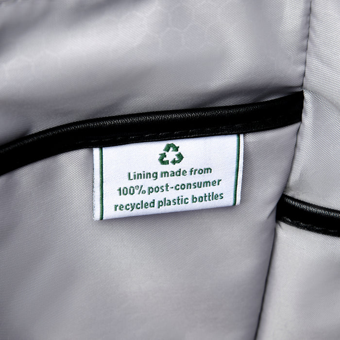 close up of the interior fabric tag in the black travelpro maxlite women's tote stating lining made from 100 percent post consumer recycled plastic bottles with a green recycling symbol.