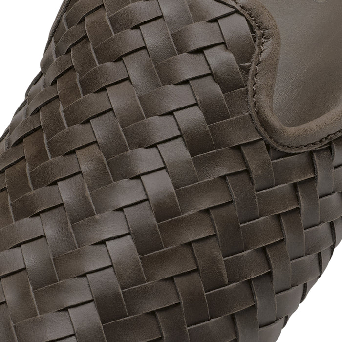 Dark brown woven leather bag with interlocking strap pattern and curved handle detail.