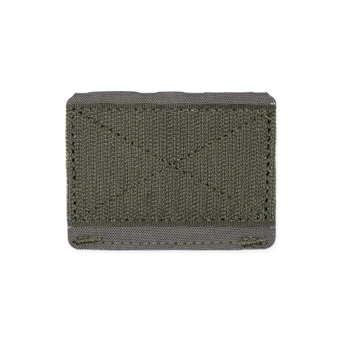 The back of a ranger green Kore Essentials Molle Extender on a White Background