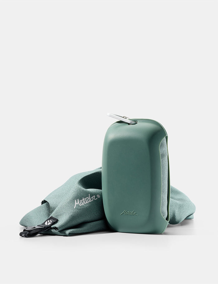 green towel and silicone case on white