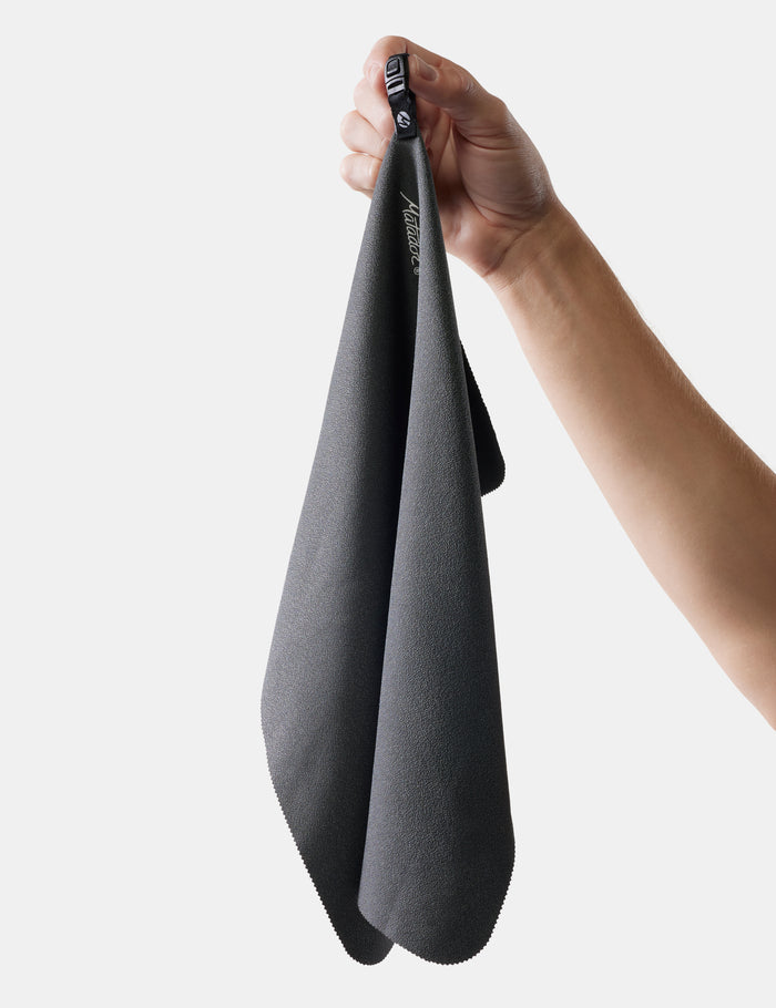 hand holding small nanodry towel on white background