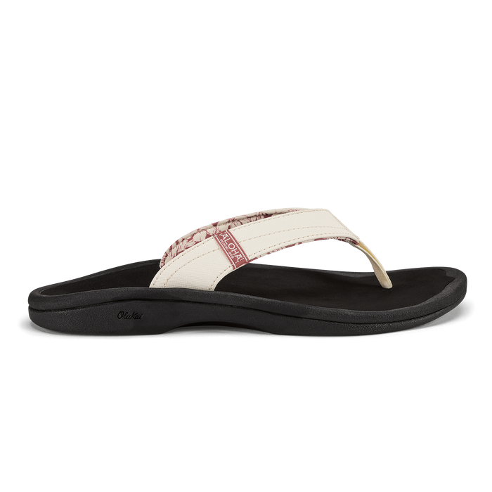 White and black thong sandal with cushioned sole and textured upper strap detail.