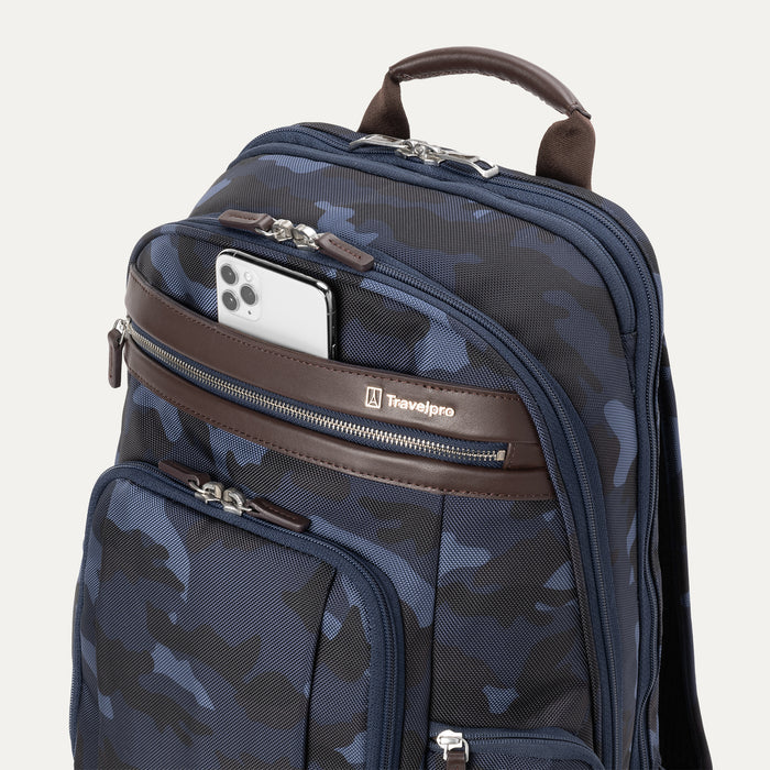 Platinum® Elite Business Backpack in camouflage with a brown leather accent zipper pocket, holding a silver smartphone in the front zippered compartment.