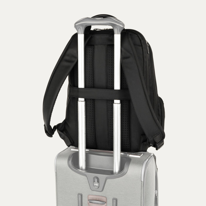rear view of the black travelpro platinum elite business laptop backpack 27l stacked on a silver hardside suitcase, showing the integrated trolley strap slid over the luggage handle for secure travel.