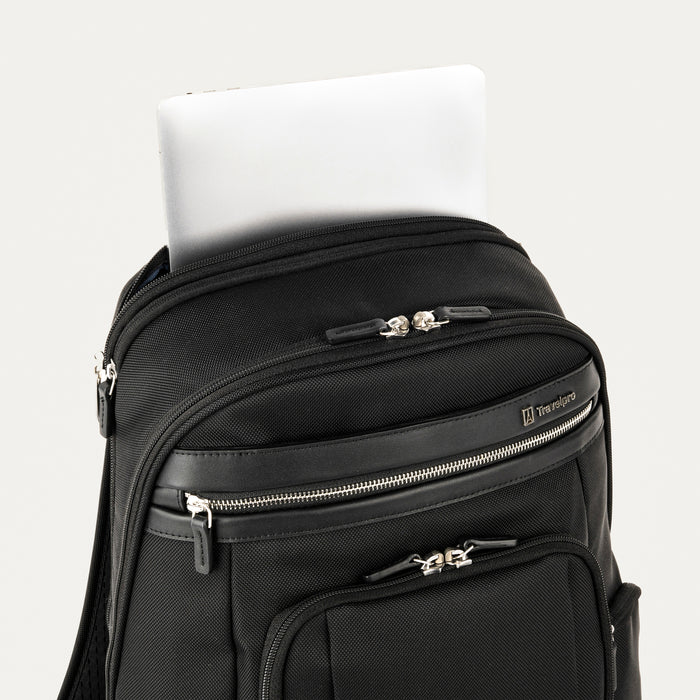 close-up view of the black travelpro platinum elite business laptop backpack 27l, showing a white tablet being tucked into the dedicated padded electronics sleeve located at the top of the main compartment.