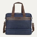 front view of the true navy travelpro platinum elite drop-bottom weekender bag, featuring its signature two-compartment design with premium brown leather trim, chrome zippers, and a removable shoulder strap.