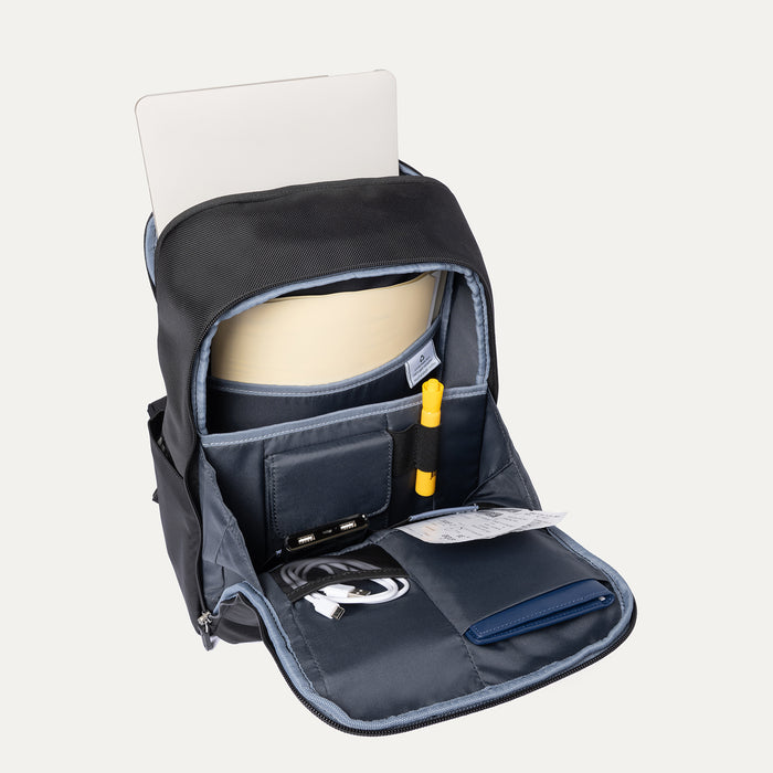 top-down interior view of the shadow black travelpro platinum® elite slim laptop backpack 16l, showing the organized main compartment with a laptop, tablet, charging cables, passport, and boarding passes against a grey lining.