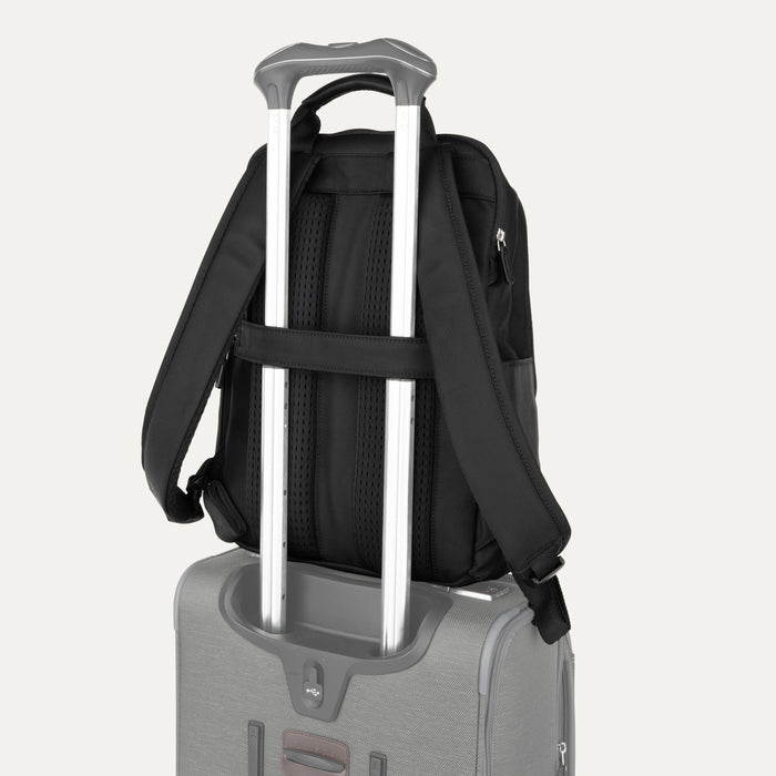 rear view of the shadow black travelpro platinum® elite slim laptop backpack 16l stacked on a grey rolling suitcase, showing the integrated trolley strap secured over the extension handle.