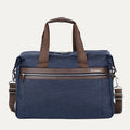 Front view of the Travelpro Platinum Elite Soft Duffel in True Navy, showing brown leather trim, dual top handles, front zippered pocket, and detachable shoulder strap against a white background.