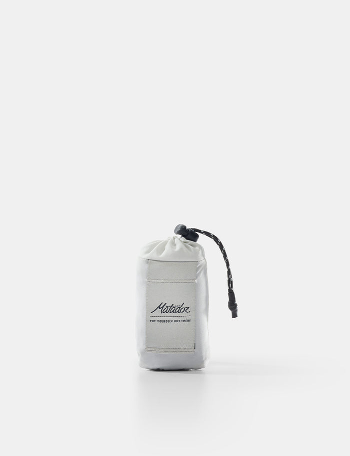 White drawstring bag with black branding on a white background