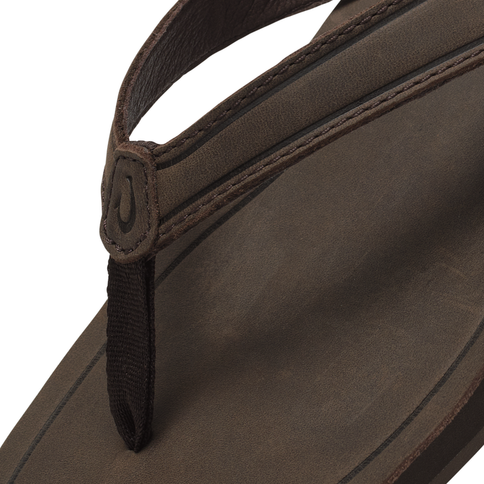 Dark brown leather handbag with dual handles and stitched detailing on the body.