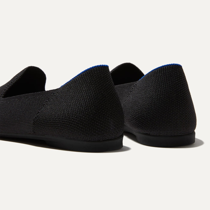 Close up of the heel of The Almond Loafer in Black, with Rothy's signature blue halo.