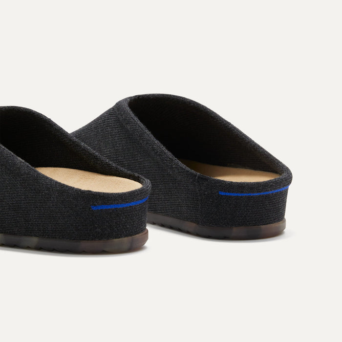 Close up of the heel of The Casual Clog in Soft Black, with Rothy's signature blue halo.
