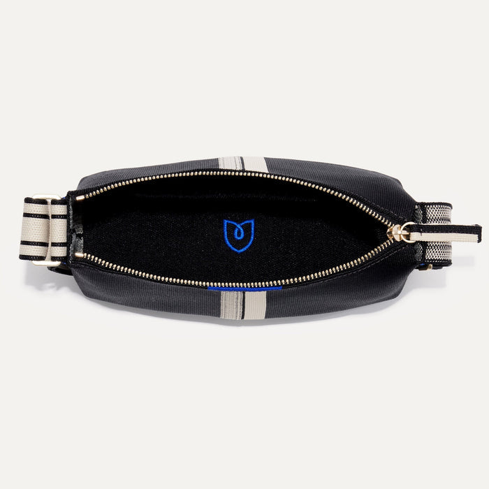 The Casual Crossbody in Black & Ivory Stripe, shown from above, with the interior exposed.