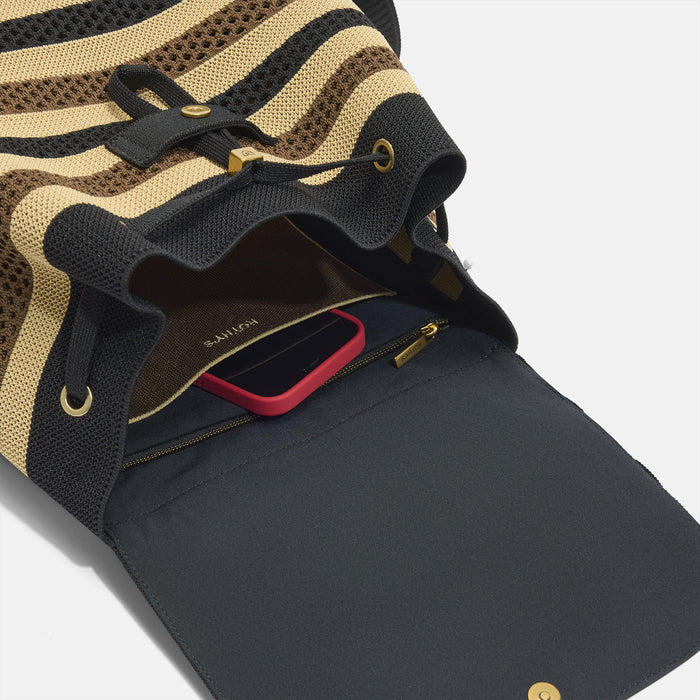 A close up of the interior pocket on The Cinch Backpack in Mocha Stripe Crochet