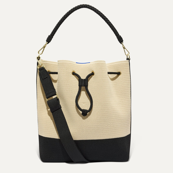 PDP |The Cinch Bucket Bag in Black and White Raffia-Knit shown from the front.