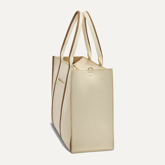 The Classic Tote in Buttercream, shown from the side.