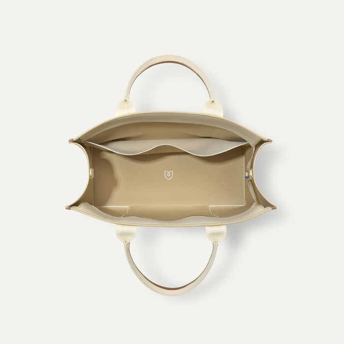 The Classic Tote in Buttercream, shown from above, with the interior exposed.