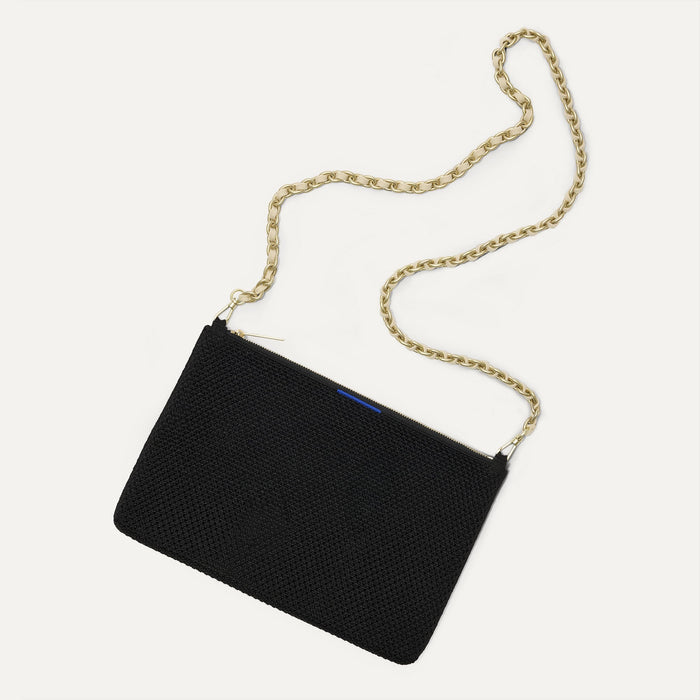Overlay:: Shown with The Crossbody Strap (sold separately). | Alt:: An image of The Convertible Clutch in Black Espresso Open Knit paired with The Crossbody Strap.