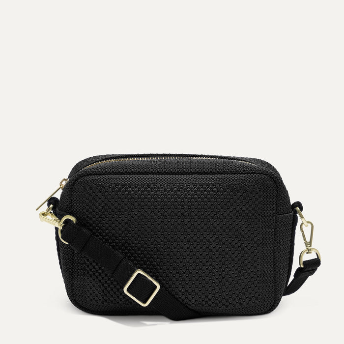 PDP |The Crossbody Camera Bag in  Black Licorice Open-Knit, shown from the front.