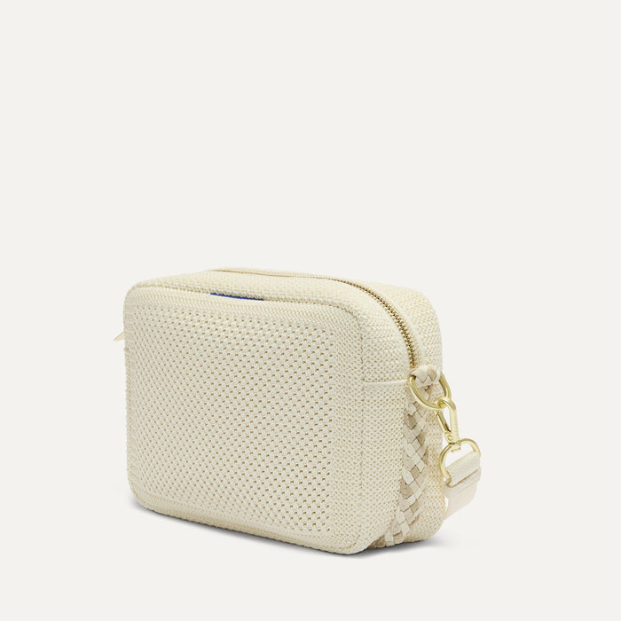 The Crossbody Camera Bag in  Cream Twist Open-Knit, shown from the side.