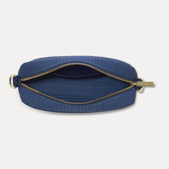 The Crossbody Camera Bag in Lagoon Open-Knit, shown from above, with the interior exposed.