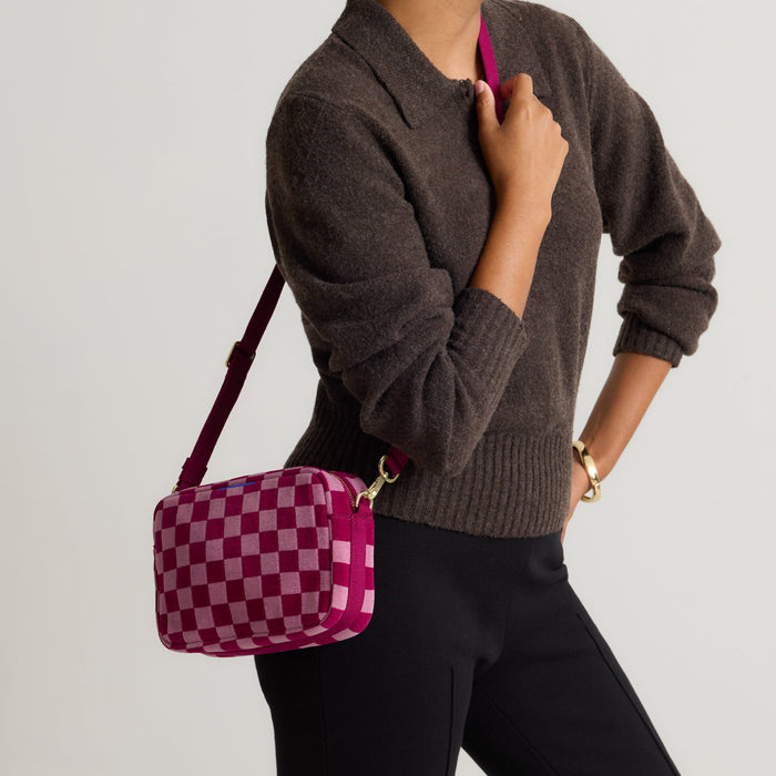 hover | Model wearing The Crossbody Camera Bag in  ReVelvet™  Orchid, shown from the front.