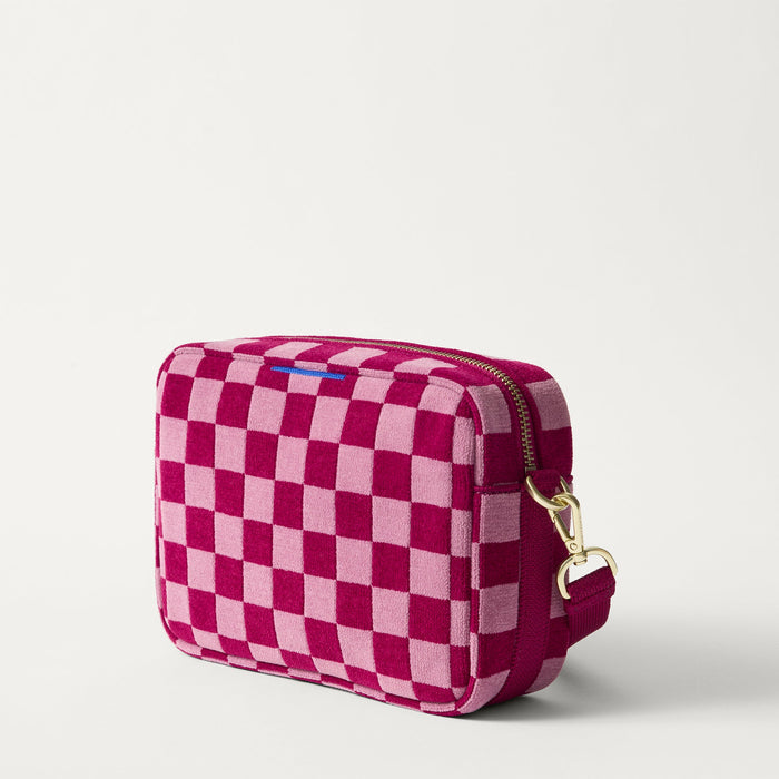 The Crossbody Camera Bag in  ReVelvet™ Orchid, shown from the side.