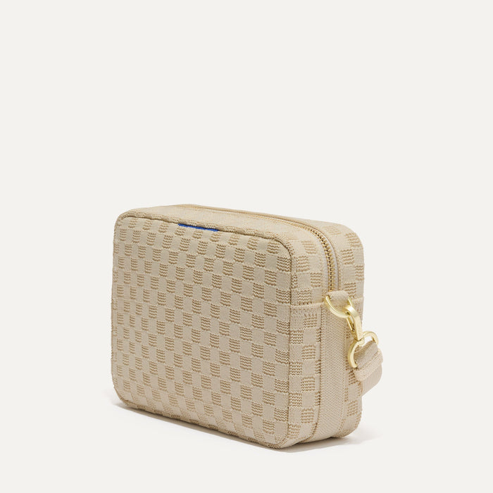 The Crossbody Camera Bag in  Sesame, shown from the side.