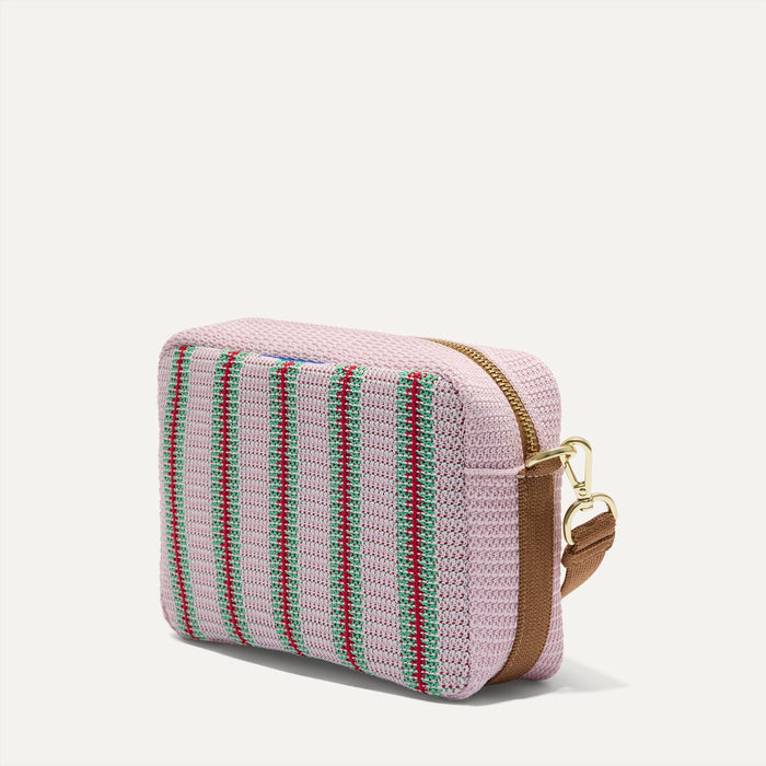 The Crossbody Camera Bag in  Watermelon Market Stripe, shown from the side.