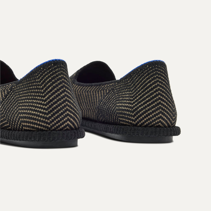 Close up of the heel of The Cruiser Loafer in ReVelvet Jet Herringbone, with Rothy's signature blue halo.