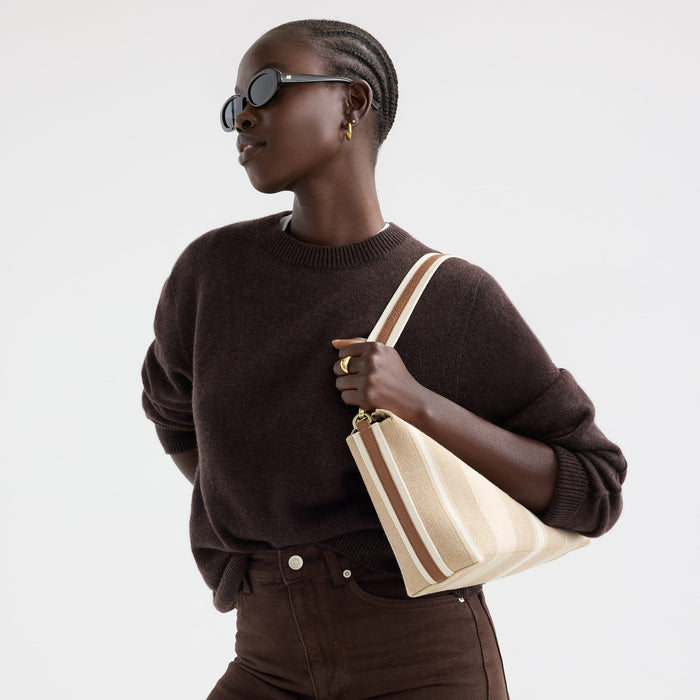 hover | Model wearing The Daily Crossbody in Oat Latte.