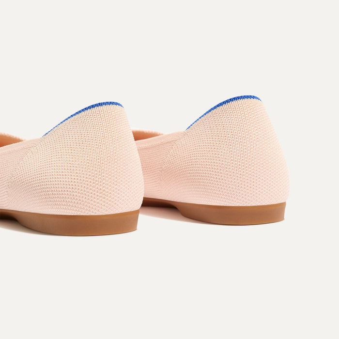Close up of the heel of The Daily Flat in Bubbly Pink, with Rothy's signature blue halo.