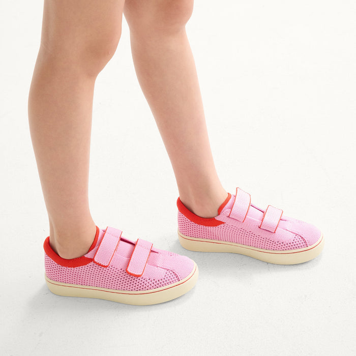 hover | A child modeling The Kids Strap Sneaker in Tutu Open-Knit.